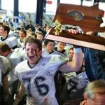 Foxborough-12/06/14- High School Superbowls- Cohasset vs Littleton- Cohasset's Eliot Keniley holds up the Super Bowl trophy. Boston Globe staff Photo by John Tlumacki(sports)