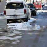 Residents across Boston use an array of items as parking savers after a snowstorm