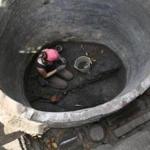 Boston, MA--8/31/2016--Archaeologist and volunteer Elizabeth Neill (cq) works in the cistern. The dig of the Unity Court Tenements in Washington Park Garden at old North Church (cq) is photographed, on Wednesday, August 31, 2016. Photo by Pat Greenhouse/Globe Staff Topic: oldnorth Reporter: Brian Macquarrie