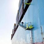 Boston Harbor pilots climb from motorboats onto foreign vessels via ladders the ships let down.