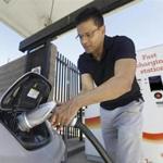 In this photo taken Thursday, Sept. 17, 2015, Darshan Brahmbhatt, plugs a charger into his electric vehicle at the Sacramento Municipal Utility District charging station in Sacramento, Calif. Climate change legislation signed Wednesday, Oct. 7 by Gov. Jerry Brown calls for major utilities to compete as an alternative transportation fuel source by installing thousands of charging stations where people live, work and play. (AP Photo/Rich Pedroncelli)