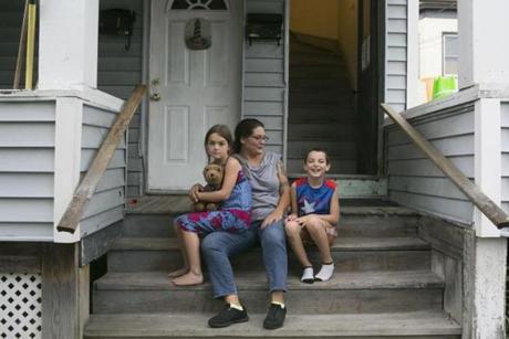 Kate Lauzon, 40, with two of her children. She receives disability payments and works several part-time jobs.
