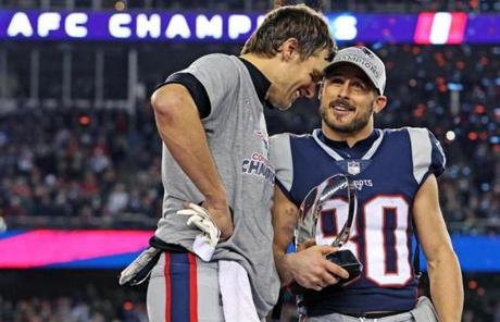 AFC PATRIOTS SLIDER Foxborough, MA 1-21-18: Patriots quarterback Tom Brady (left) and his teammates earned the right to go for their 6th Super Bowl title by beating the Jaguars 24-20. He is pictured with teammate Danny Amendola, who is cluthcing the Lamar Hunt Trophy, signifying the AFC Championship. The New England Patriots hosted the Jacksonville Jaguars in the AFC Championship Game at Gillette Stadium. (Jim Davis/Globe Staff)
