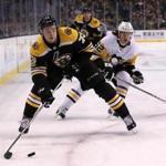 Boston MA 11/24/17 Boston Bruins Charlie McAvoy controls the puck with pressure from Pittsburg Penguins Carl Hagelin during first period NHL action at the TD Garden. (Matthew J. Lee/Globe staff) topic reporter: 