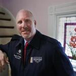 OutVets founder Bryan Bishop poses in his house in Boston, Friday, March 10, 2017. The organizers of Boston's embattled St. Patrick's Day parade have scheduled an emergency meeting to reconsider their vote to shut out the gay veterans group. This week's decision to bar OutVets from marching drew immediate condemnation from high-profile politicians and stirred up a furor on social media. (AP Photo/Michael Dwyer)