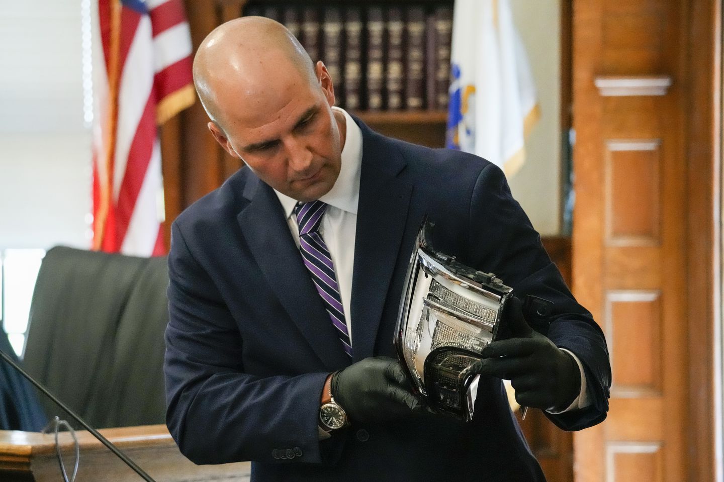 Massachusetts State Police Trooper Michael Proctor showed the jury a broken taillight while testifying on Monday at Norfolk Superior Court in Dedham, during the murder trial of Karen Read.