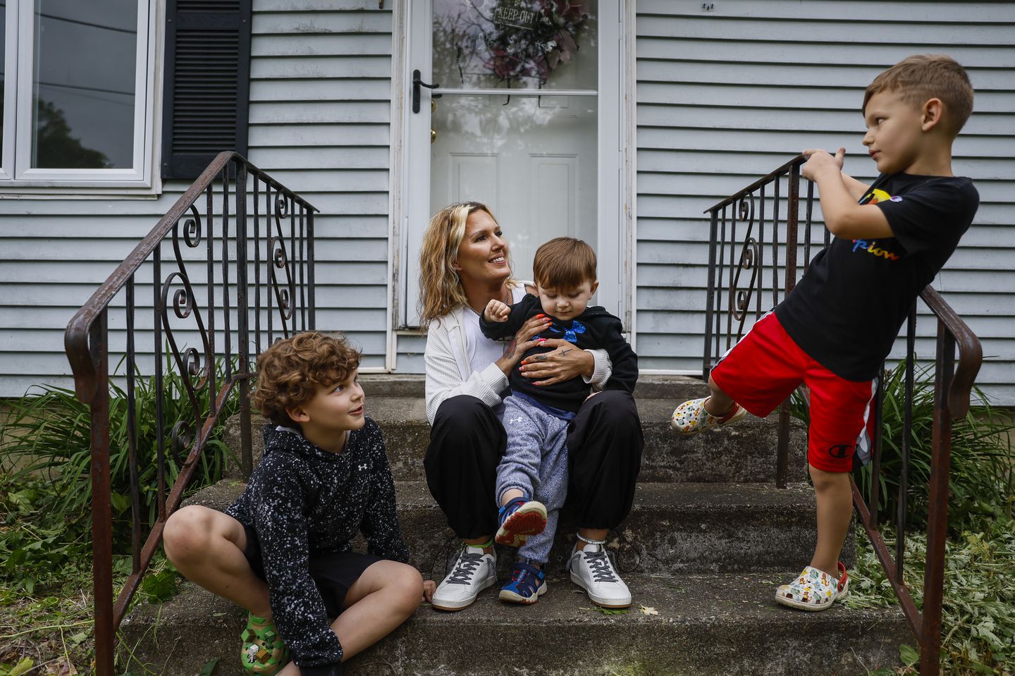 Kayla Ford sat on her front stoop with her three sons. Ford was in recovery and taking Suboxone when she was reported to DCF following the birth of each of her children.