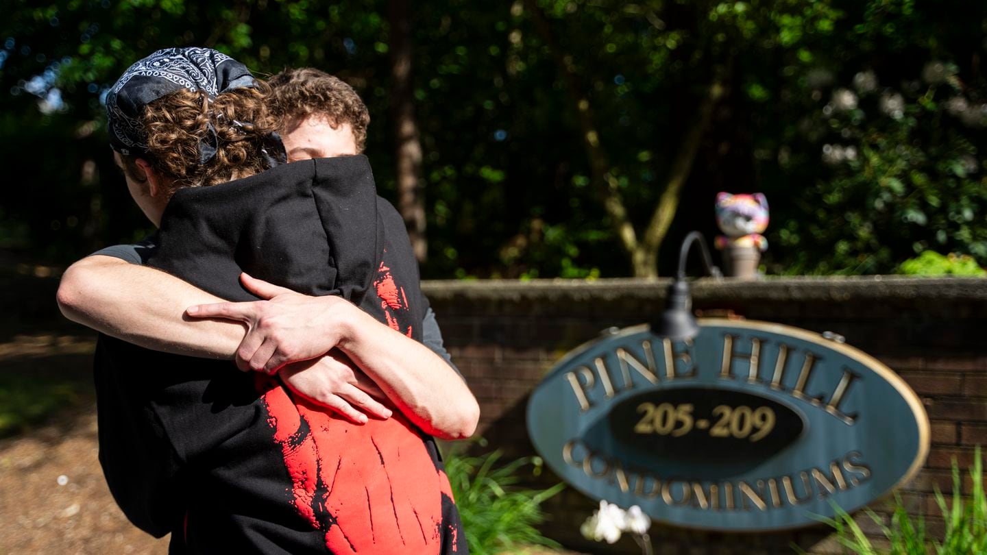 Tenth-graders Ben Stimac and Colin Beers-Murphy embraced on May 5 at the memorial site Beers-Murphy created for their classmate who died in a murder-suicide. She was killed by her stepfather, Juliano Santana, the previous day. Santana was charged in 2021 for raping his stepdaughter and she had an active restraining order against him.