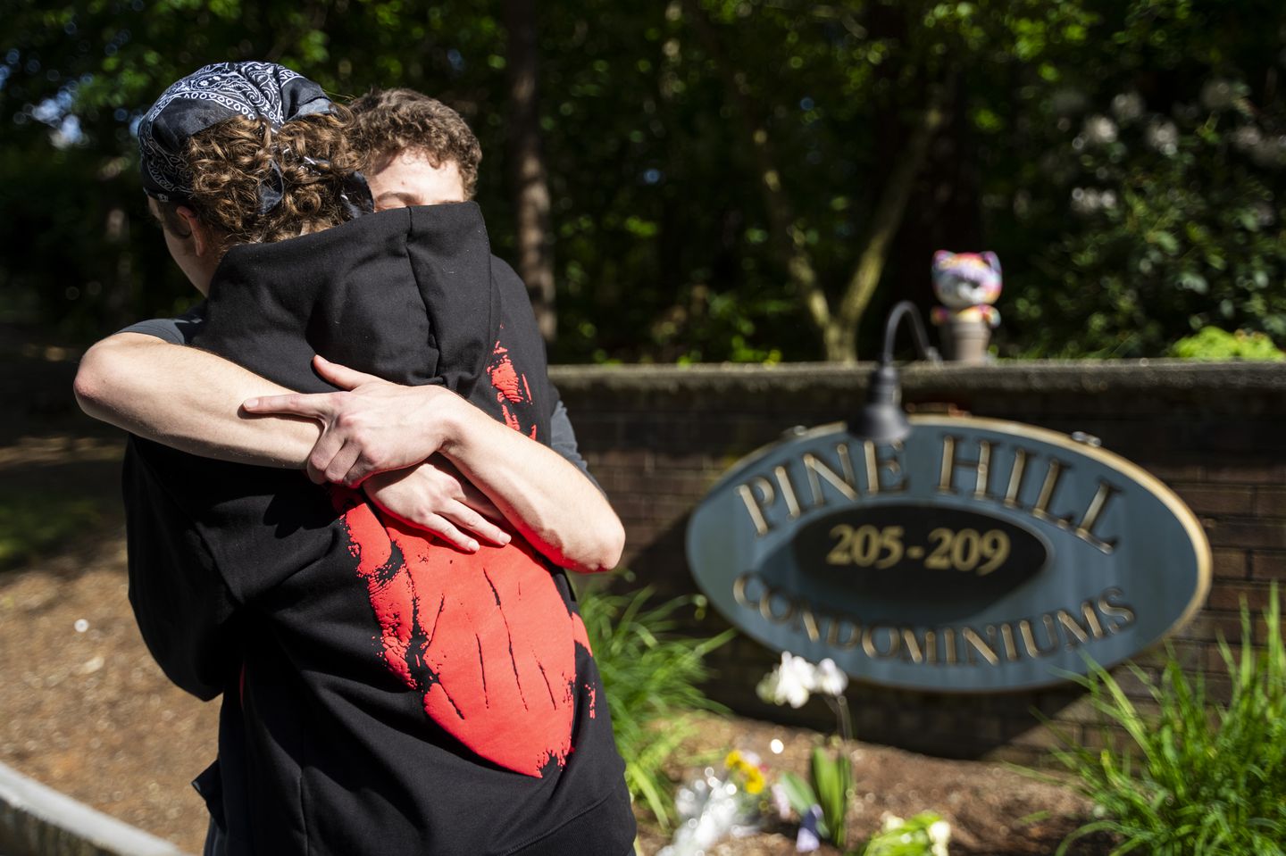Tenth-graders Ben Stimac and Colin Beers-Murphy embraced on May 5 at the memorial site Beers-Murphy created for their classmate who died in a murder-suicide. She was killed by her stepfather, Juliano Santana, the previous day. Santana was charged in 2021 for raping his stepdaughter and she had an active restraining order against him.