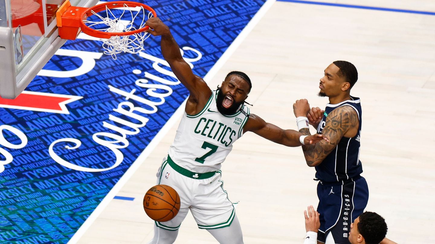 Jaylen Brown slams a ferocious dunk past the Mavericks' P.J. Washington during the third quarter on Wednesday in Dallas.