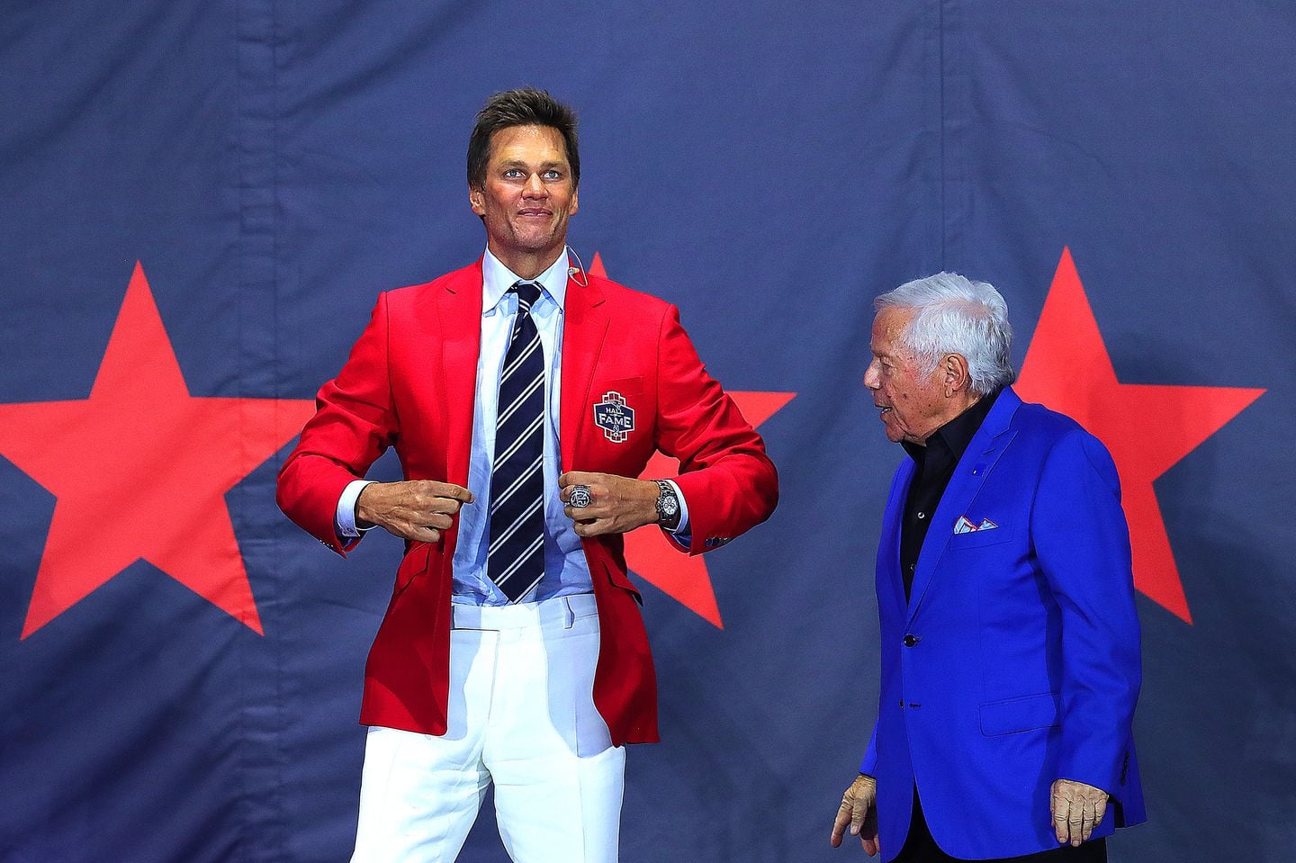 Tom Brady shows off his new red jacket given to him by Robert Kraft as he was inducted into the Patriots Hall of Fame.