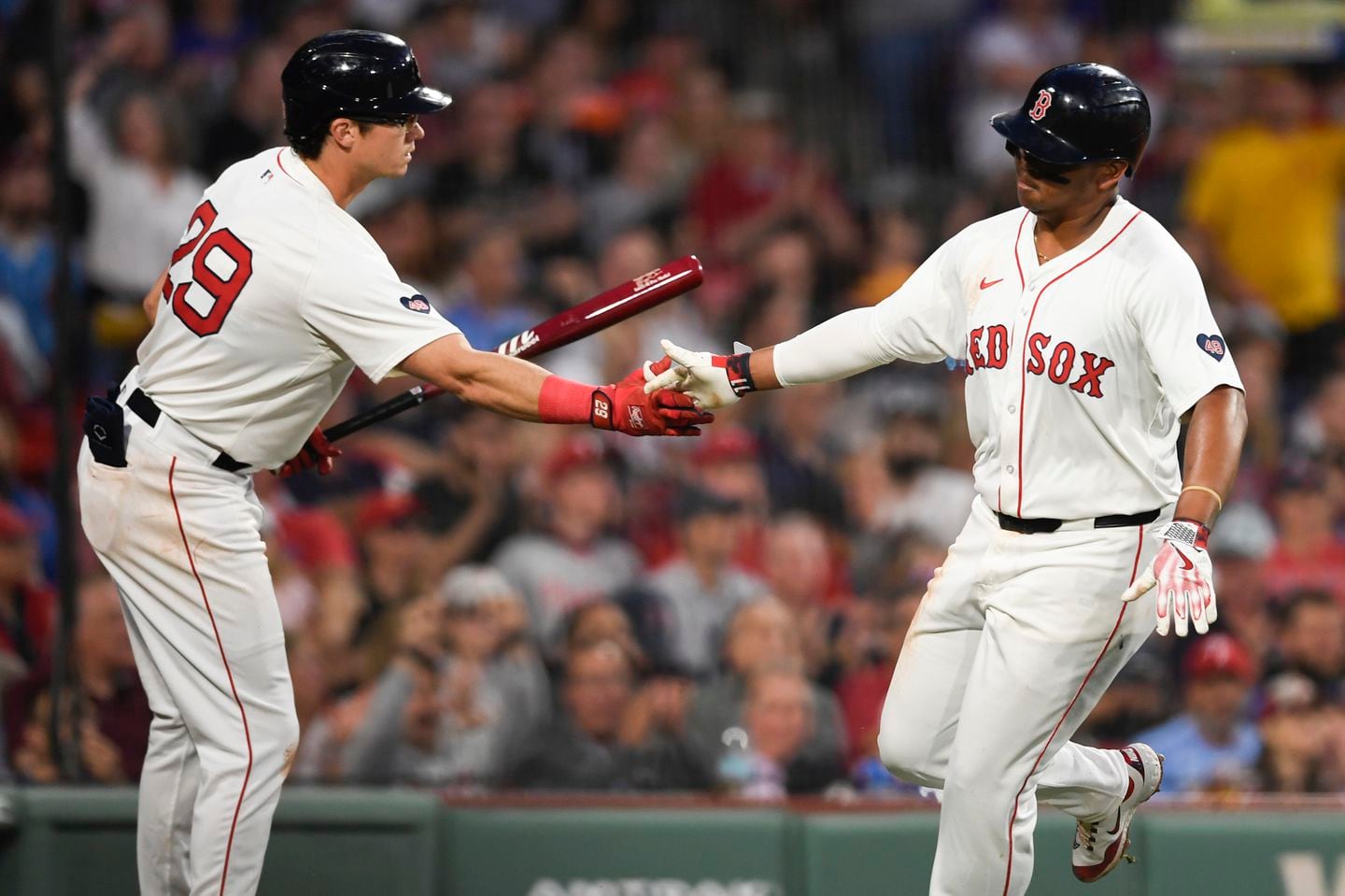 Bobby Dalbec ( left), greets Rafael Devers at home after scoring off a sacrifice fly hit by Jamie Westbrook during the fourth inning. It was the Red Sox' first run and the start of rally against the Phillies.
