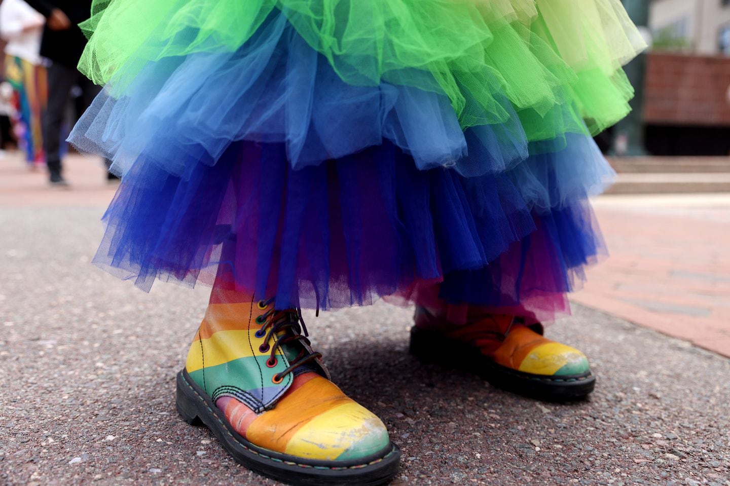 Leslie Rosenberg of Boston sported a pair of rainbow boots to match her rainbow skirt at a Pride flag raising at Boston City Hall on June 3.