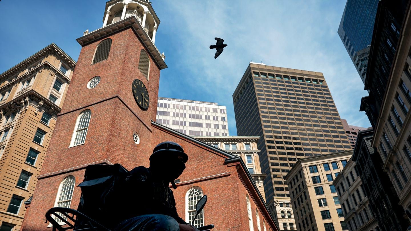 A food delivery driver from the Dominican Republic, who identified himself by his first name, William, waited for an order across from the Old South Meeting House at Downtown Crossing in Boston on June 4, 2024.