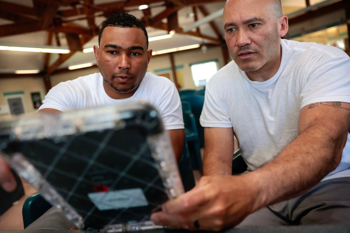 Inmates Christopher Merced (left) and David Class used an educational tablet supplied by the Massachusetts Department of Correction at the MCI-Norfolk prison.