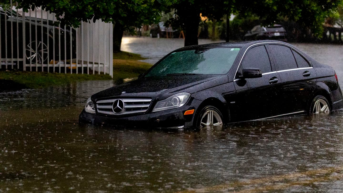 A vehicle stranded by the flooded road due to heavy rain in Sunny Isles Beach in Fla,, Wednesday, June 12, 2024.