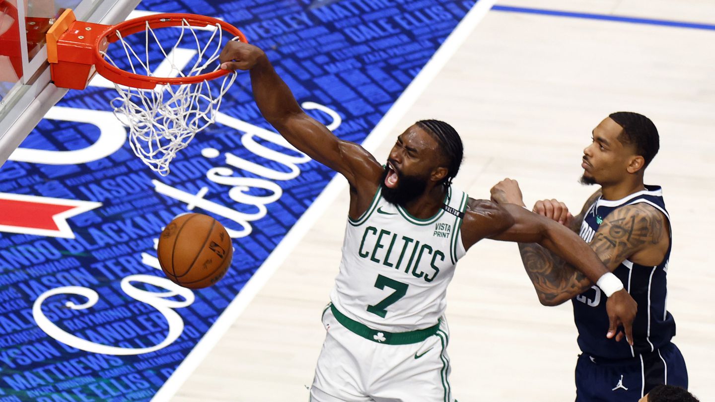 Jaylen Brown held the Mavericks' P.J. Washington back while slamming a dunk down in the third quarter.