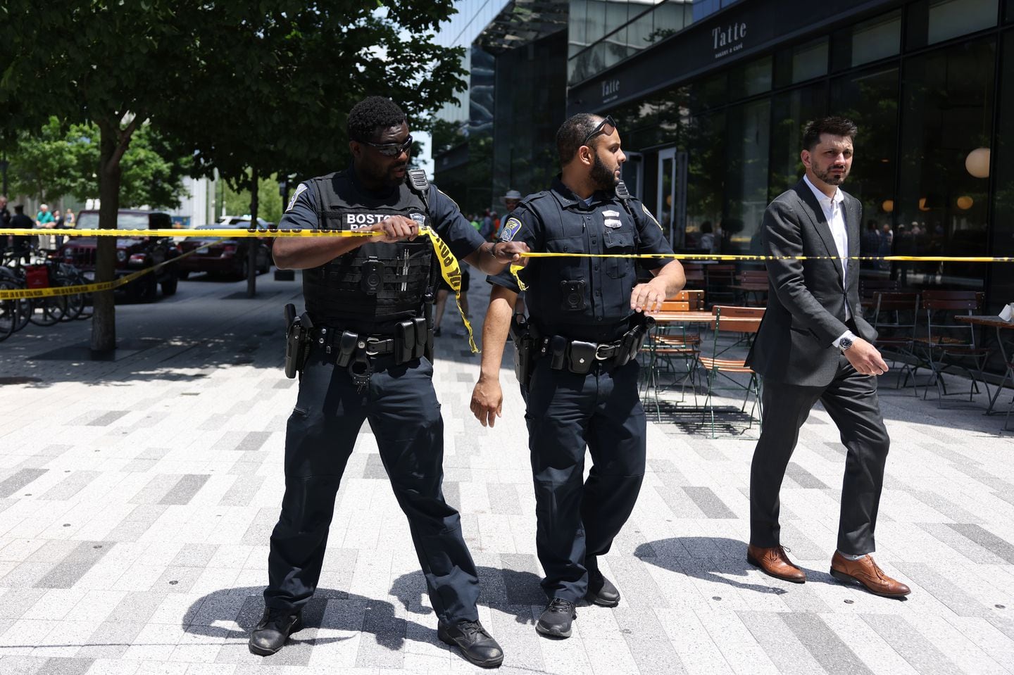 Boston police officers at a crime scene where a woman was shot in the Seaport on Thursday.