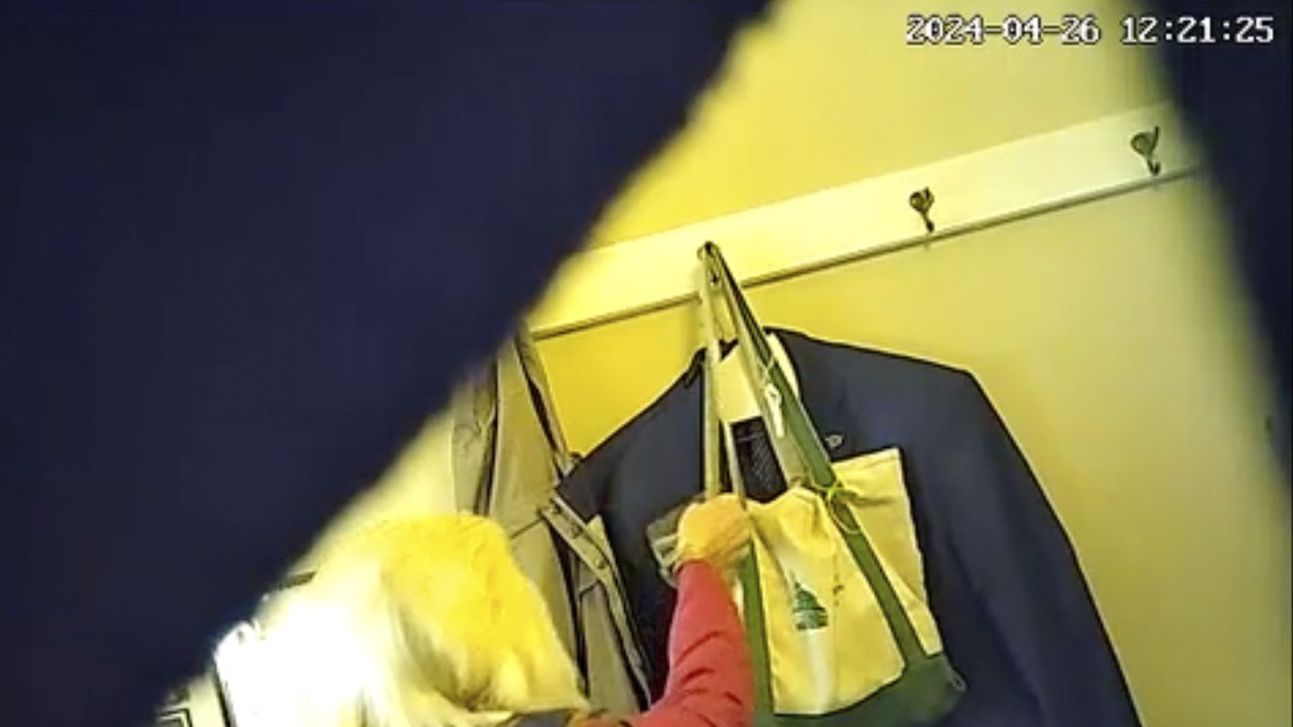 This image taken from video provided by Vermont Representative Jim Carroll, a Democrat, appears to show Representative Mary Morrissey, a Republican, pouring water into Carroll's tote bag.