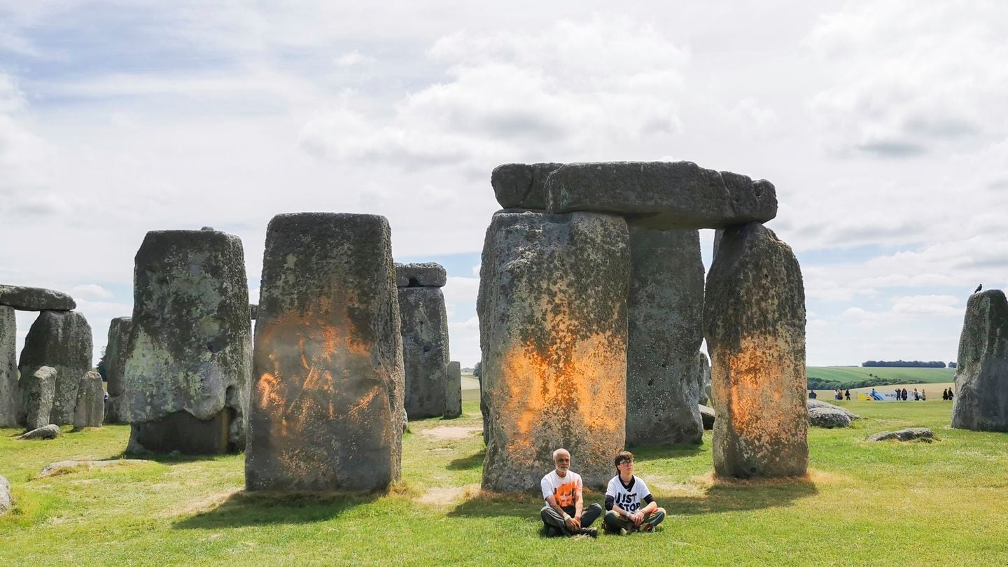 In this handout photo, Just Stop Oil protesters sat after spraing an orange substance on Stonehenge in Salisbury, England.