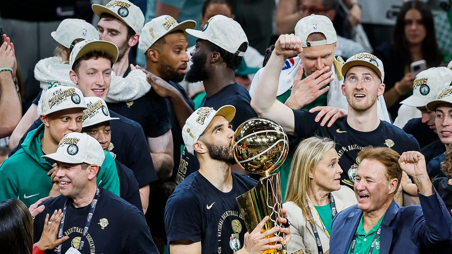 Boston Celtics forward Jayson Tatum kisses the Larry O'Brien Championship Trophy after winning the NBA Finals.