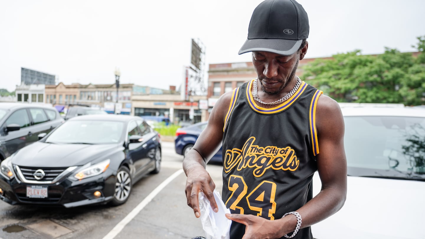 Frantz Joseph pulled paperwork from the state’s Family Welcome Center outside the Immigrant Family Services Institute in Mattapan, which is providing assistance to migrants.