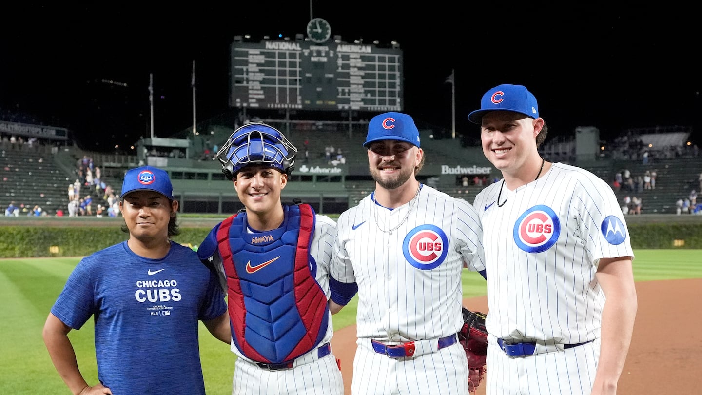 Cubs starting pitcher Shota Imanaga, catcher Miguel Amaya, and relief pitchers Porter Hodge and Nate Pearson pose after their no-hitter on Wednesday.