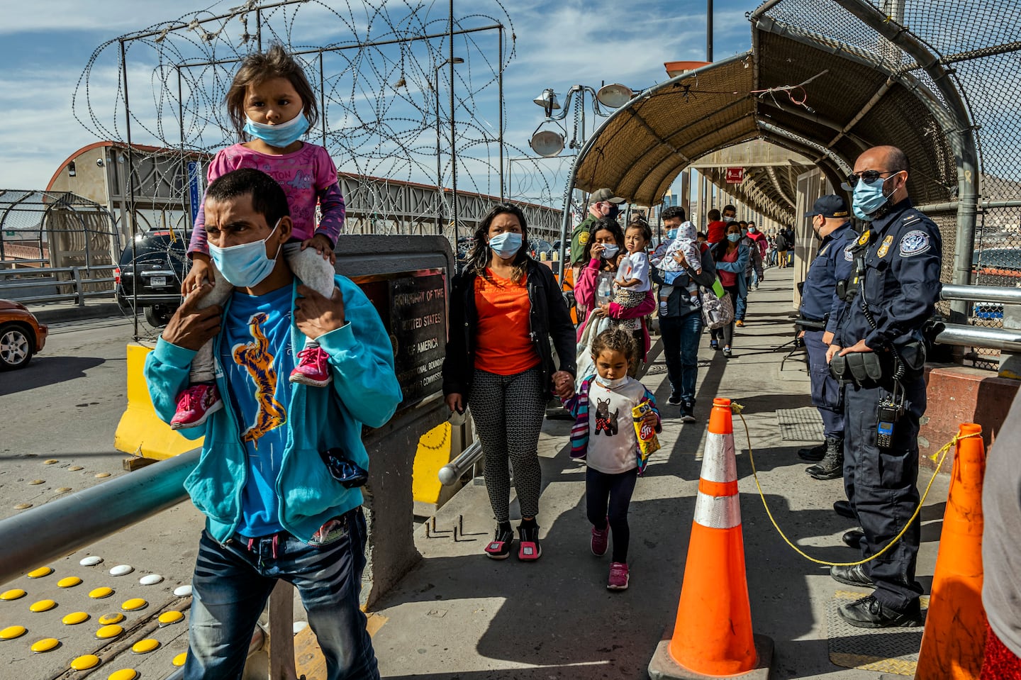 Migrants who were being deported from the United States walked along a bridge that connects El Paso and Mexico, on March 18, 2021.