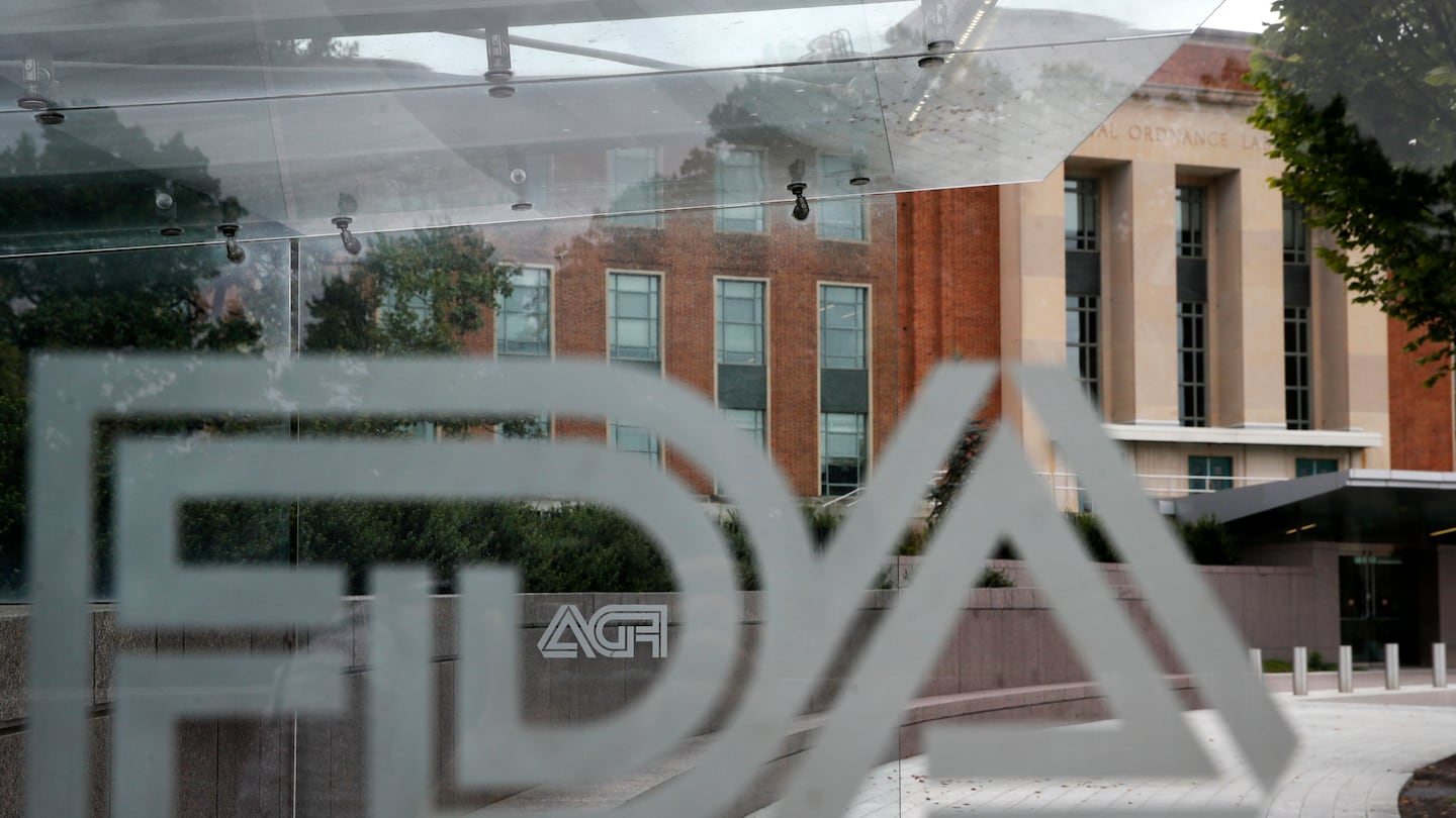 A Food and Drug Administration building is seen behind FDA logos at a bus stop on the agency's campus in Silver Spring, Md.