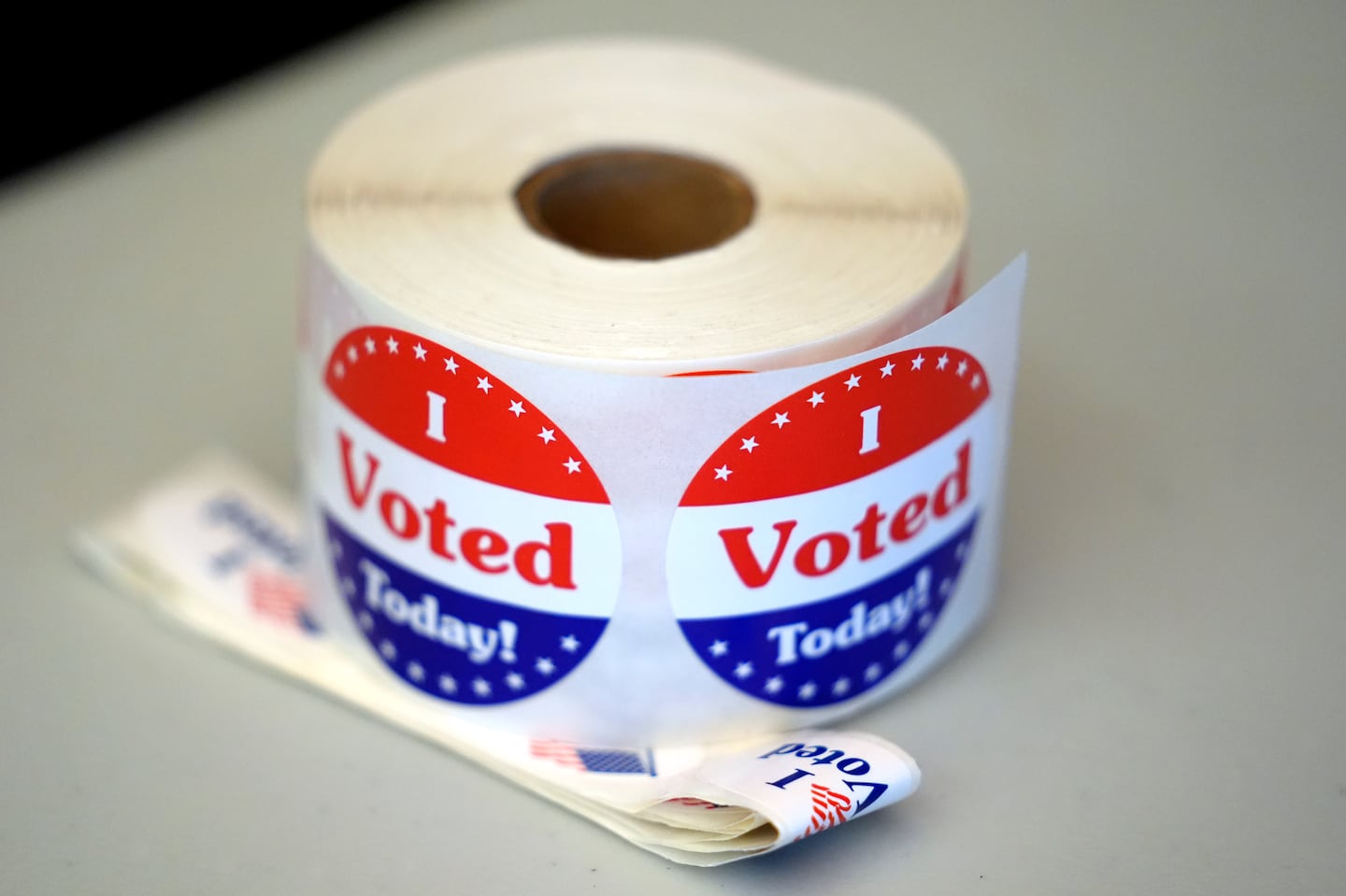 A spool of stickers rests on a table at a polling station during Massachusetts state primary voting, Tuesday, Sept. 3, 2024, at the Newton Free Library.