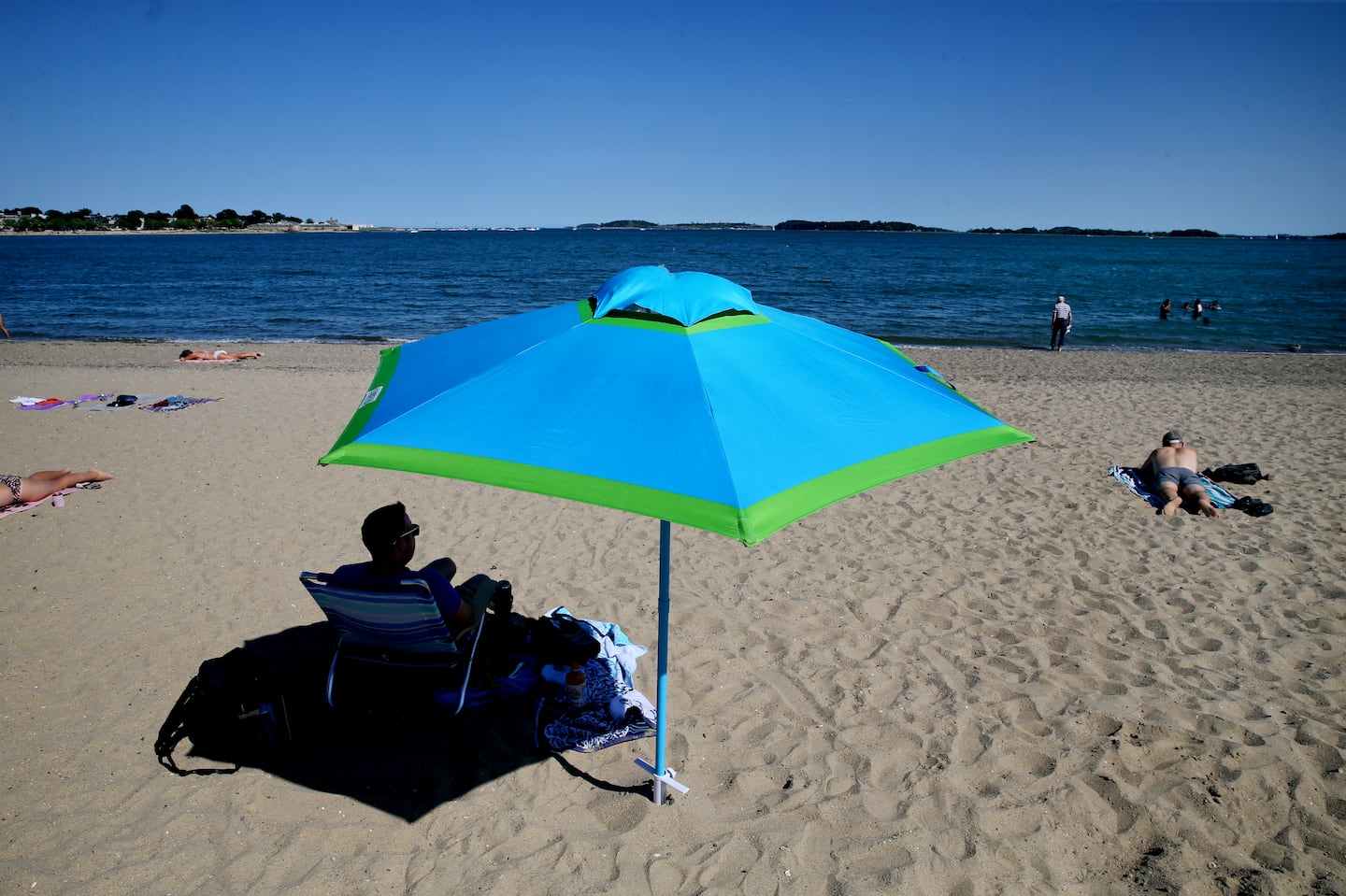 A beachgoer enjoys the Labor Day weather at Carson Beach in Boston in 2020.