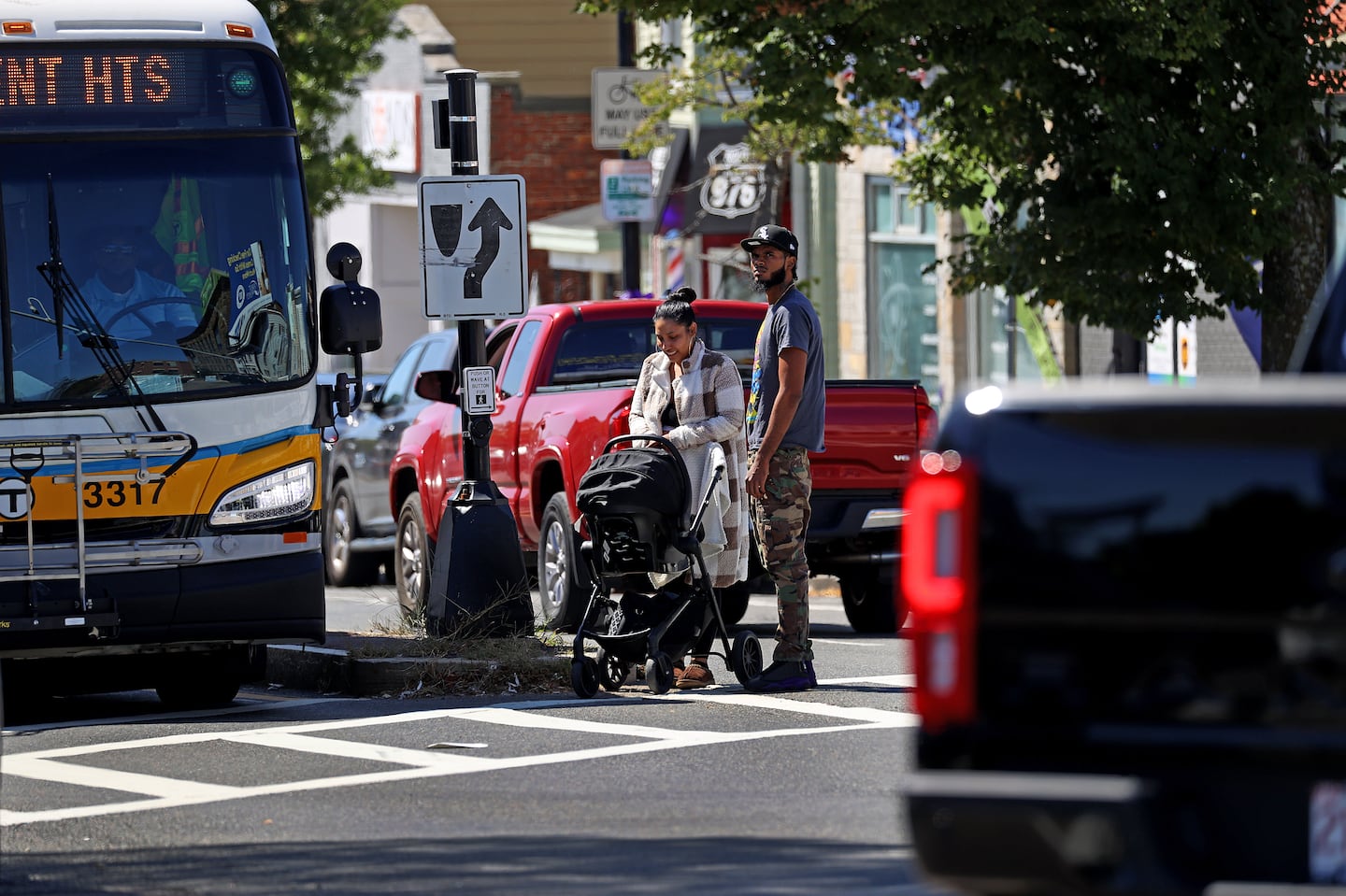 A family waited by a traffic island as the traffic lights changed to green at Bennington and Saratoga streets in East Boston.