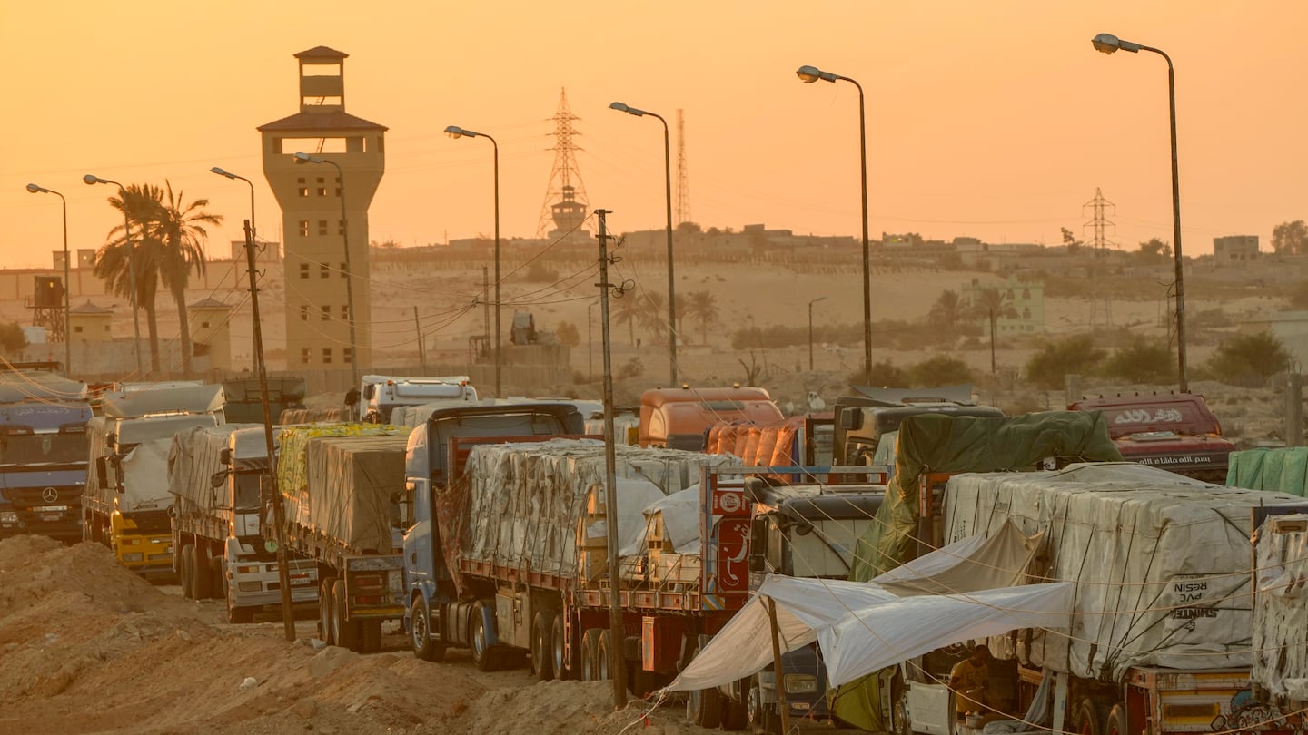 Trucks of humanitarian aids wait to cross the Rafah border crossing between Egypt and the Gaza Strip, in Rafah, Egypt, on Sept. 9.