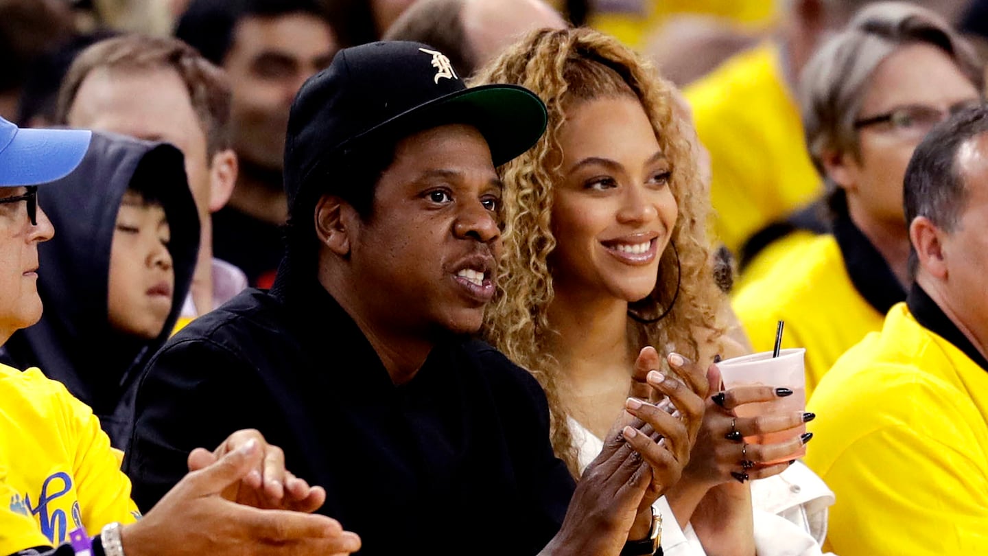 Jay-Z and Beyonce watch a playoff series between the Golden State Warriors and the New Orleans Pelicans in Oakland, Calif., in 2018.