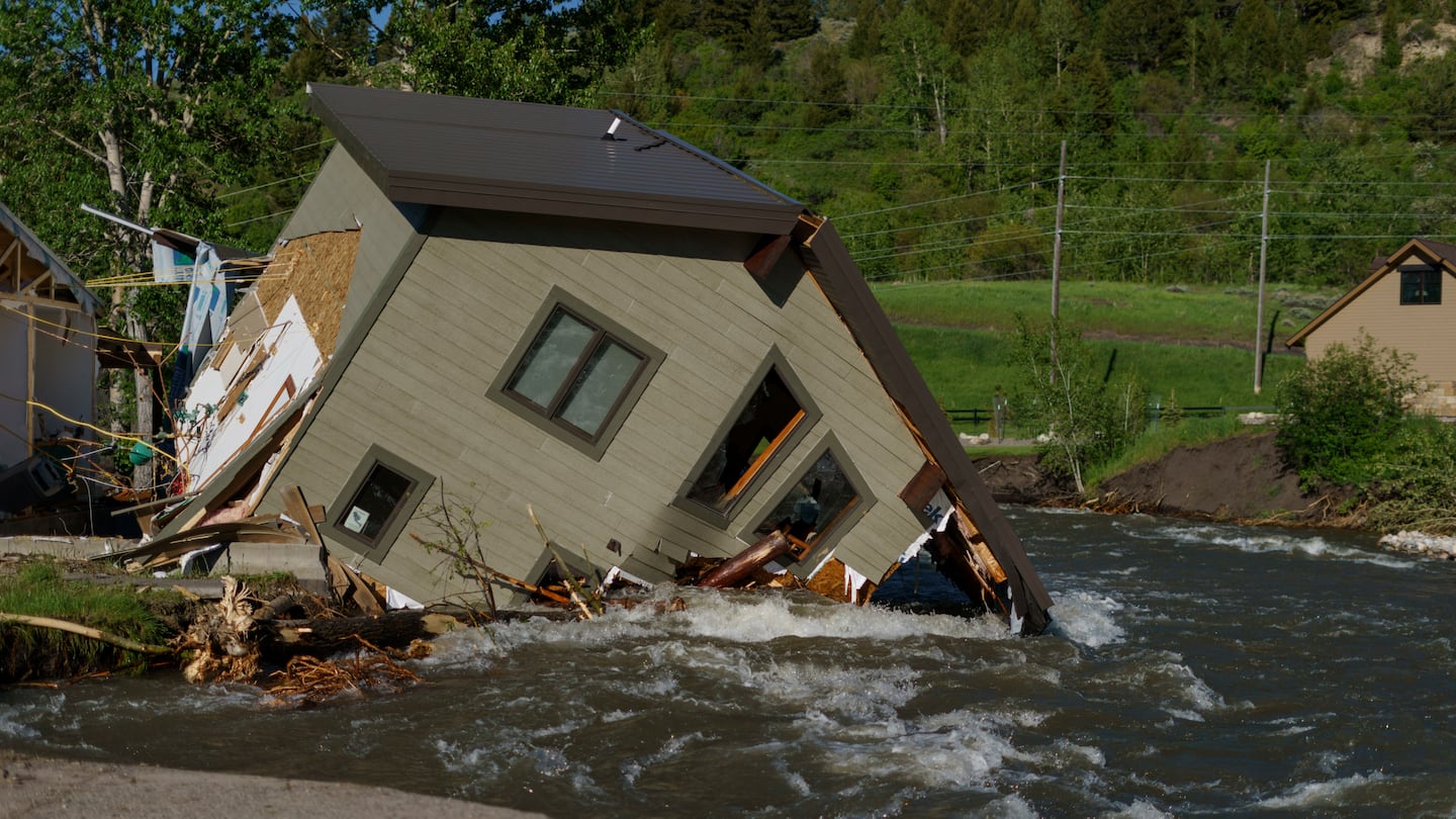 A house sat in Rock Creek after floodwaters washed away a road and bridge in Red Lodge, Mont., in June 2022.