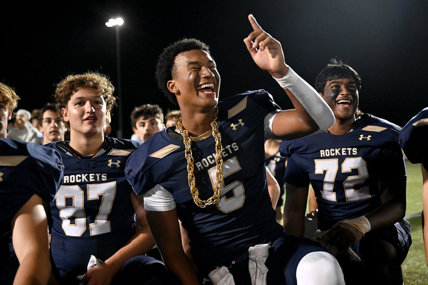 After scoring three touchdowns against Milton, Needham’s Aidan Williams (center) was sporting some extra bling. Needham opened the new season with a 24-0 victory.