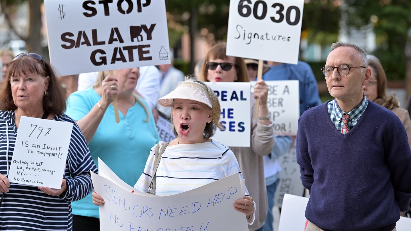 Sheila Chan, center, participated in a demonstration by a group called "A Just Quincy" at City Hall Plaza in Quincy, protesting against the raises of the mayor and councilors.