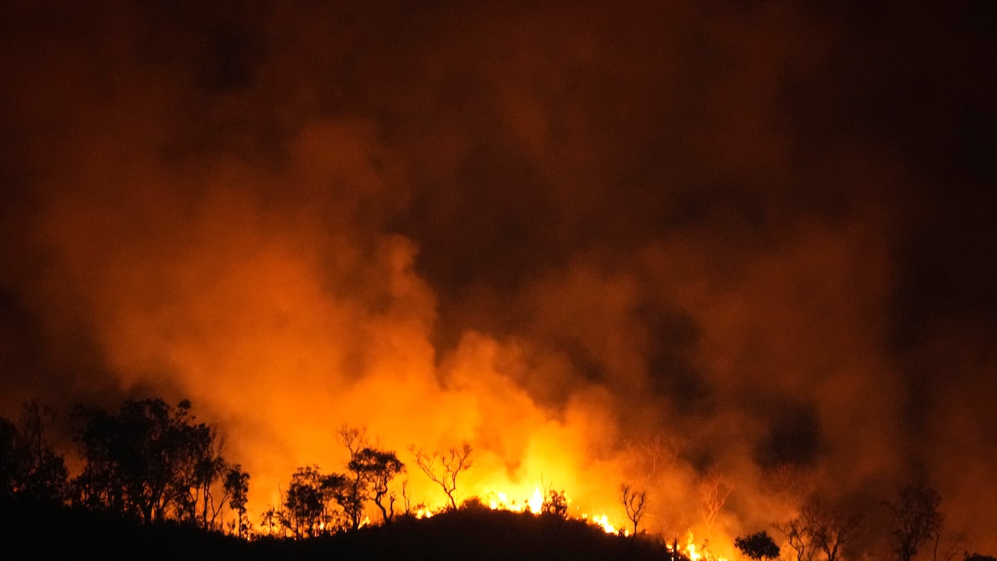 Fires spread through the environmental protection area of Pouso Alto, in Chapada dos Veadeiros National Park, during dry season, in Colinas do Sul, Goias state, Brazil, Monday.