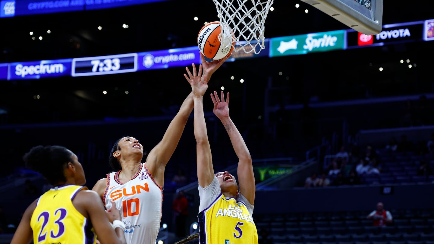 Connecticut's Olivia Nelson-Ododa rebounds over the Sparks' Dearica Hamby.