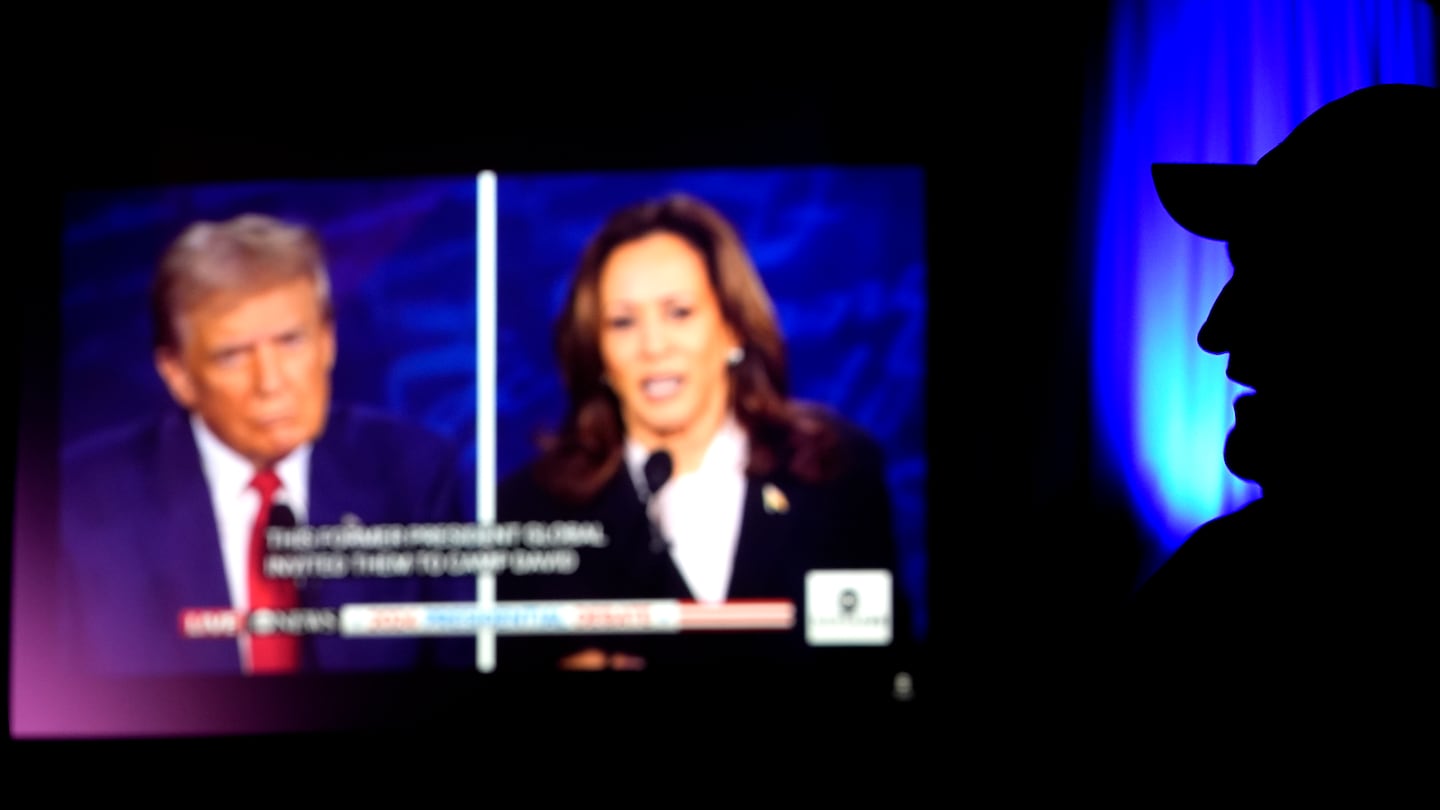 A man watched the presidential debate between Republican presidential nominee former president Donald Trump and Democratic presidential nominee Vice President Kamala Harris in Shawnee, Kan.