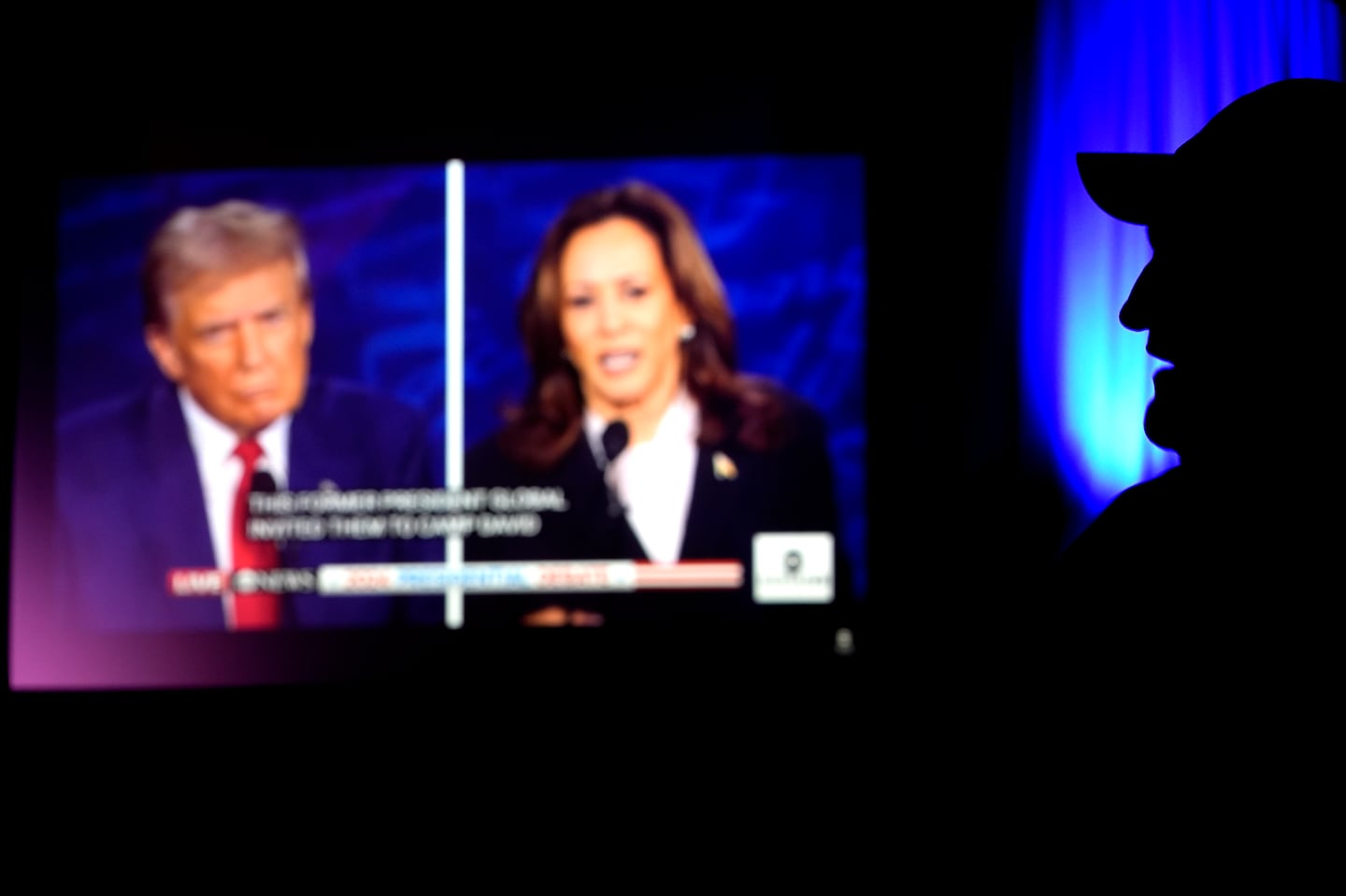 A man watched the presidential debate between Republican presidential nominee former president Donald Trump and Democratic presidential nominee Vice President Kamala Harris in Shawnee, Kan.