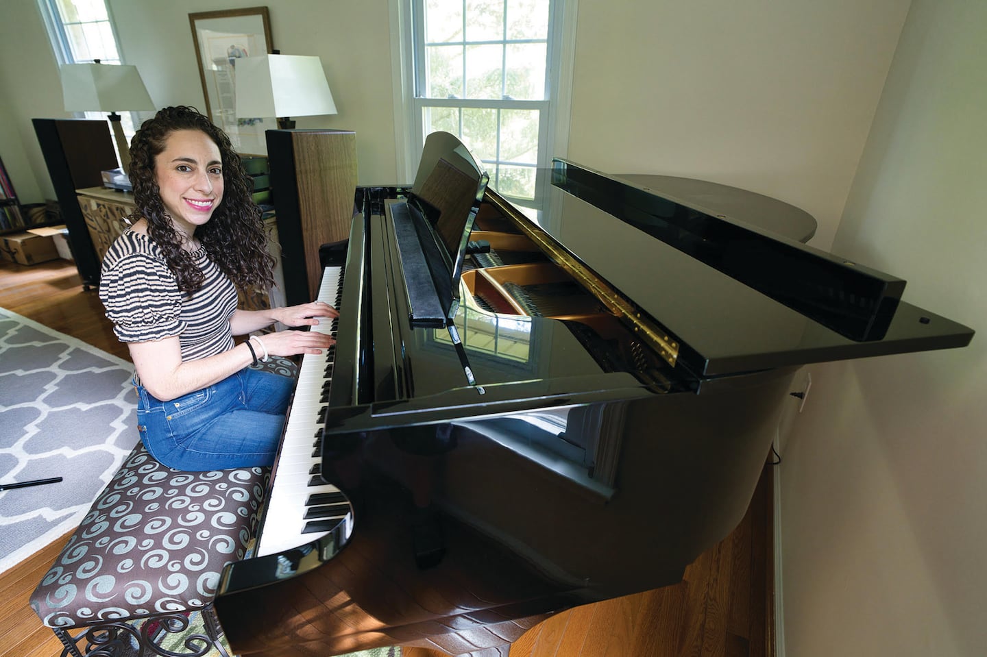 The writer playing her “new” second-hand piano.