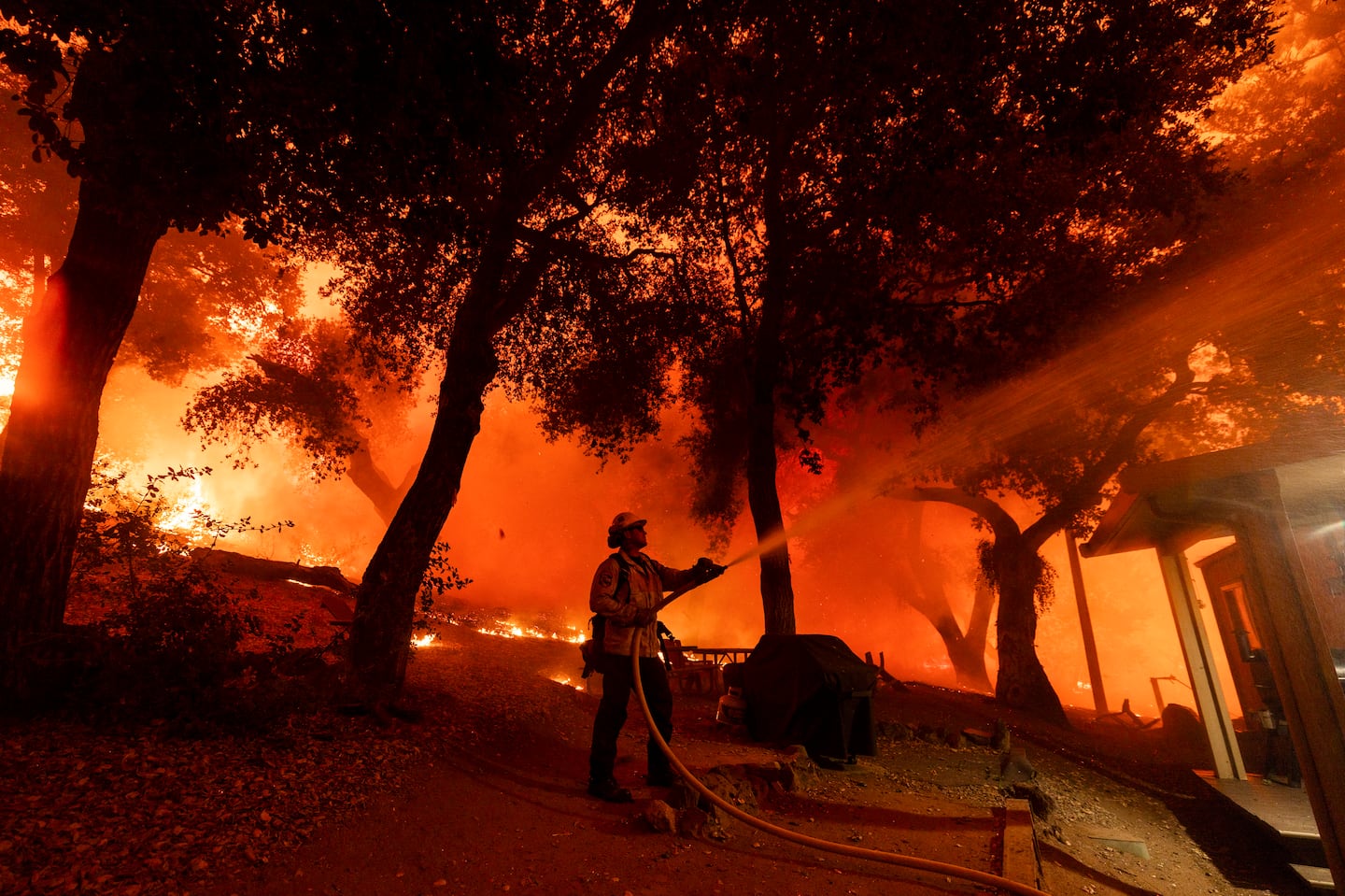 A firefighter battles the Airport Fire, Sept. 10, in El Cariso, an unincorporated community in Riverside County, Calif.