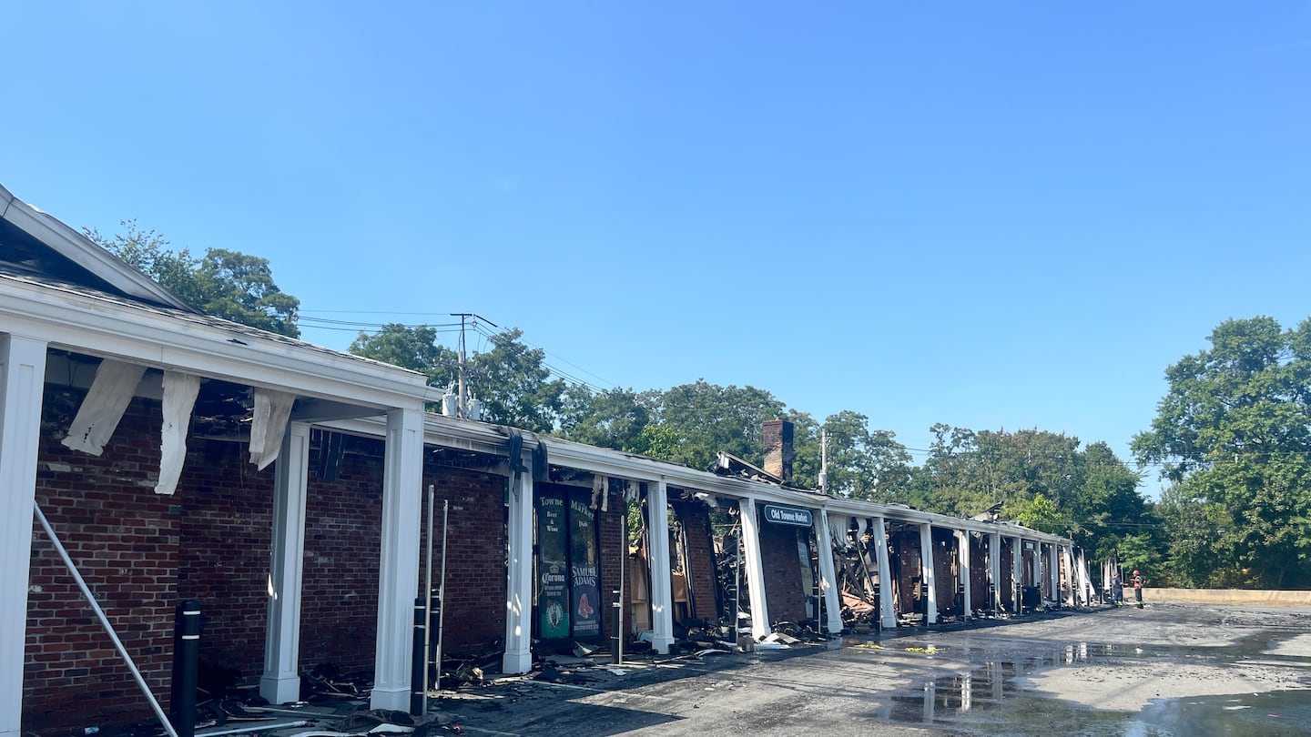 The charred remnants of the Post Office Square shopping center in Lynnfield on Wednesday. (Sabrina Lam for The Boston Globe)