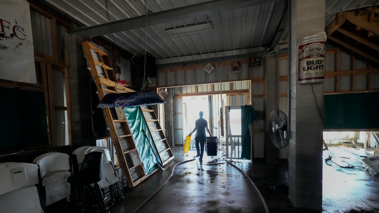 Allen McCoy helps clean out his family's camp, which took on a storm surge, in the aftermath of Hurricane Francine, in Cocodrie, La., on Sept. 12.