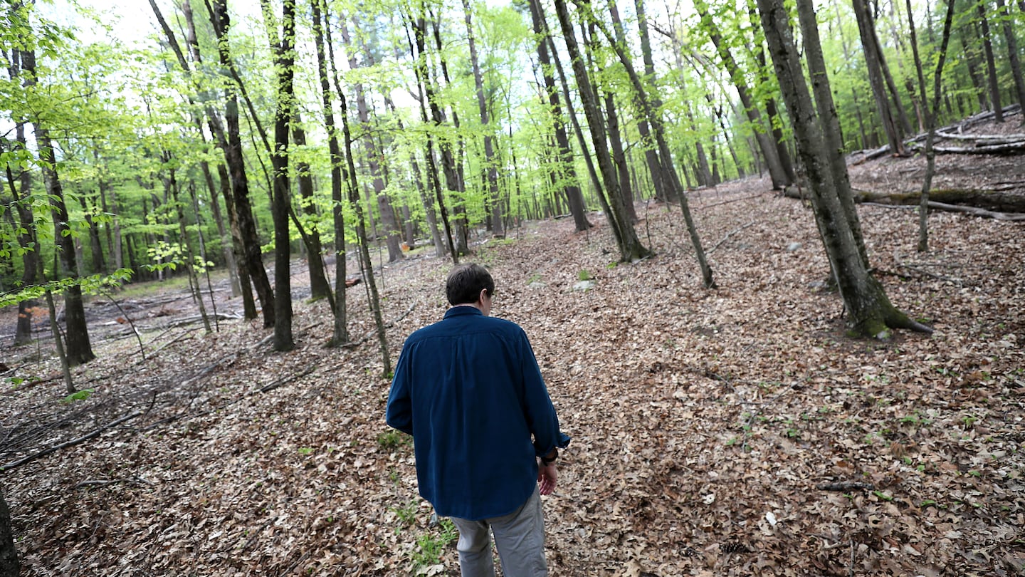 Tony Downs, who has early onset Alzheimer’s disease, took a walk in the woods near his house.