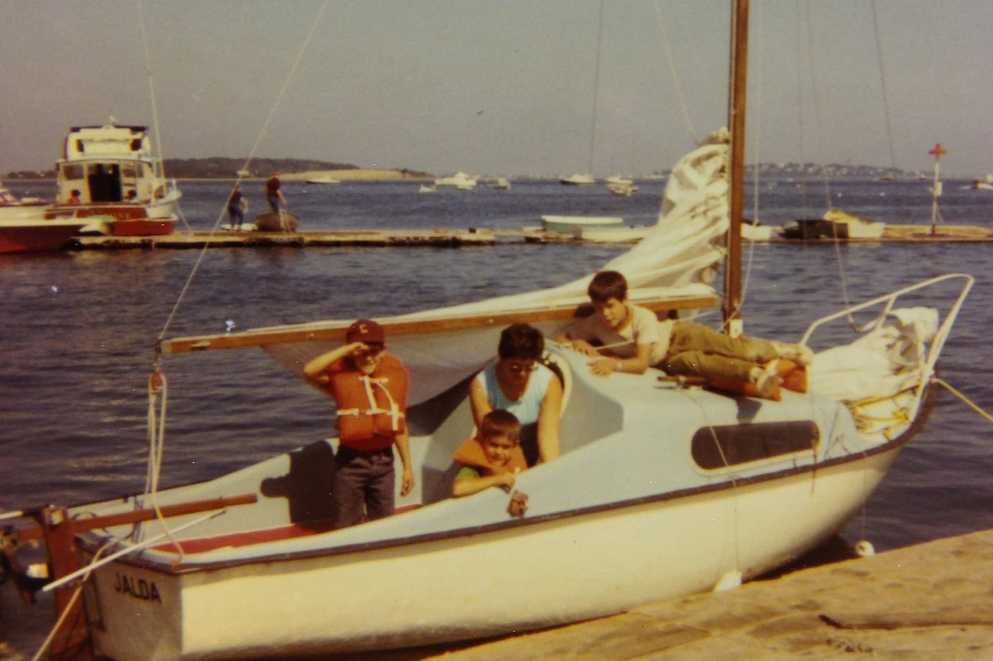 Jalda, the Filipov family's 16-foot sailboat, docked at Hough's Neck, in Quincy, circa 1969. From left, the author, his brother Jeff, mother Loretta, and brother Allan.