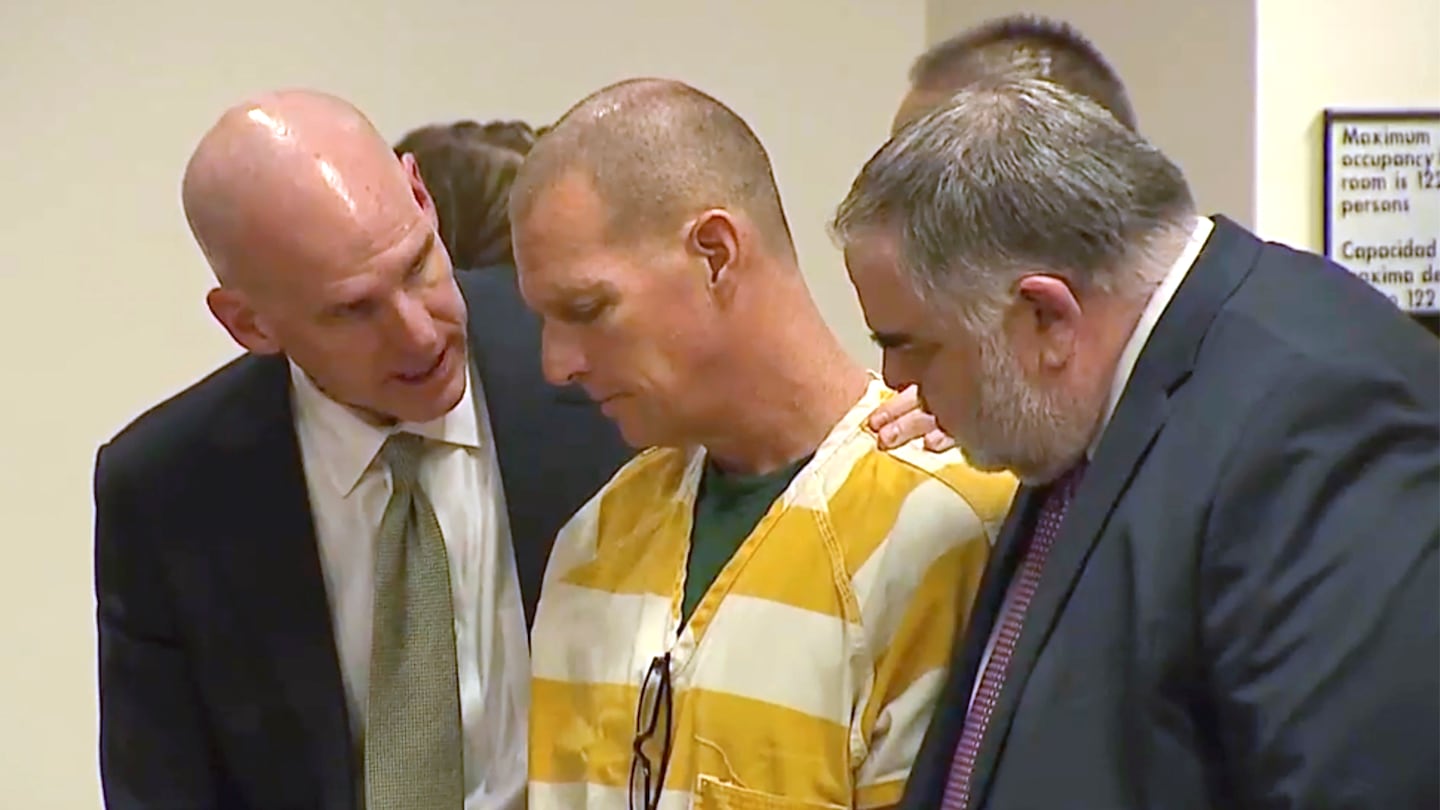 Lawyers console paramedic Peter Cichuniec after his sentence is read, March 1, 2024, in Brighton, Colo.