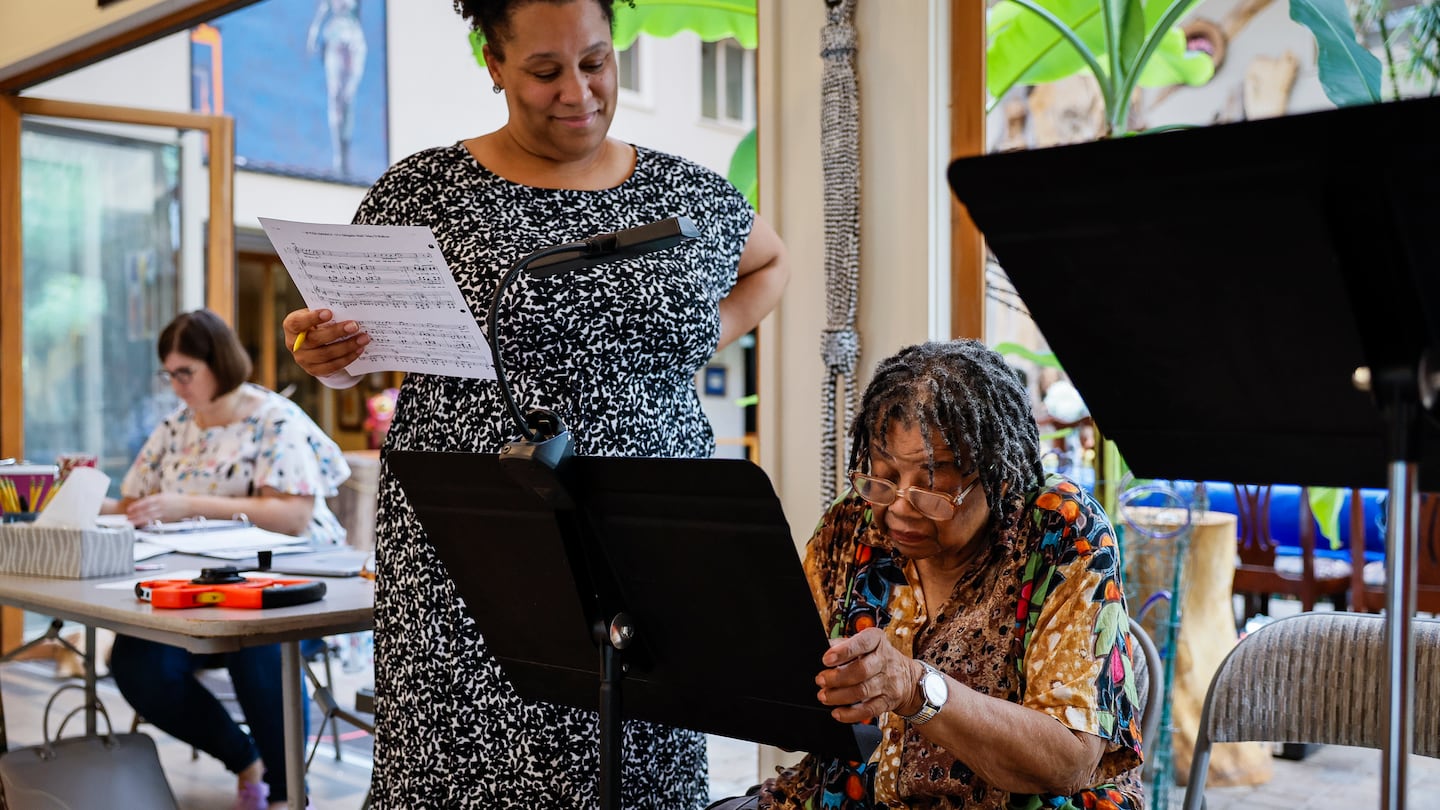 Composer Mary D. Watkins, right, reviews music with opera singer Deborah Nansteel at the home of co-librettist Cerise Lim Jacobs during a rehearsal for the new opera "Is This America?," about civil rights leader Fannie Lou Hamer.