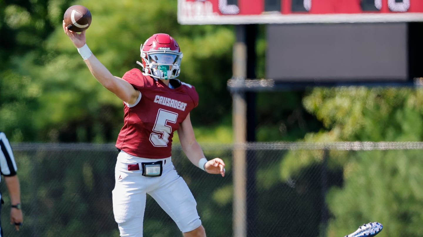 Carver senior quarterback Jack Balzarini (No. 5) throws a pass under pressure from Nantucket defender David Cirillo (No. 17) during the Crusaders' 26-15 nonleague vict- during a non-league victory on Saturday during which Balzarini threw for 256 yards and four touchowns.